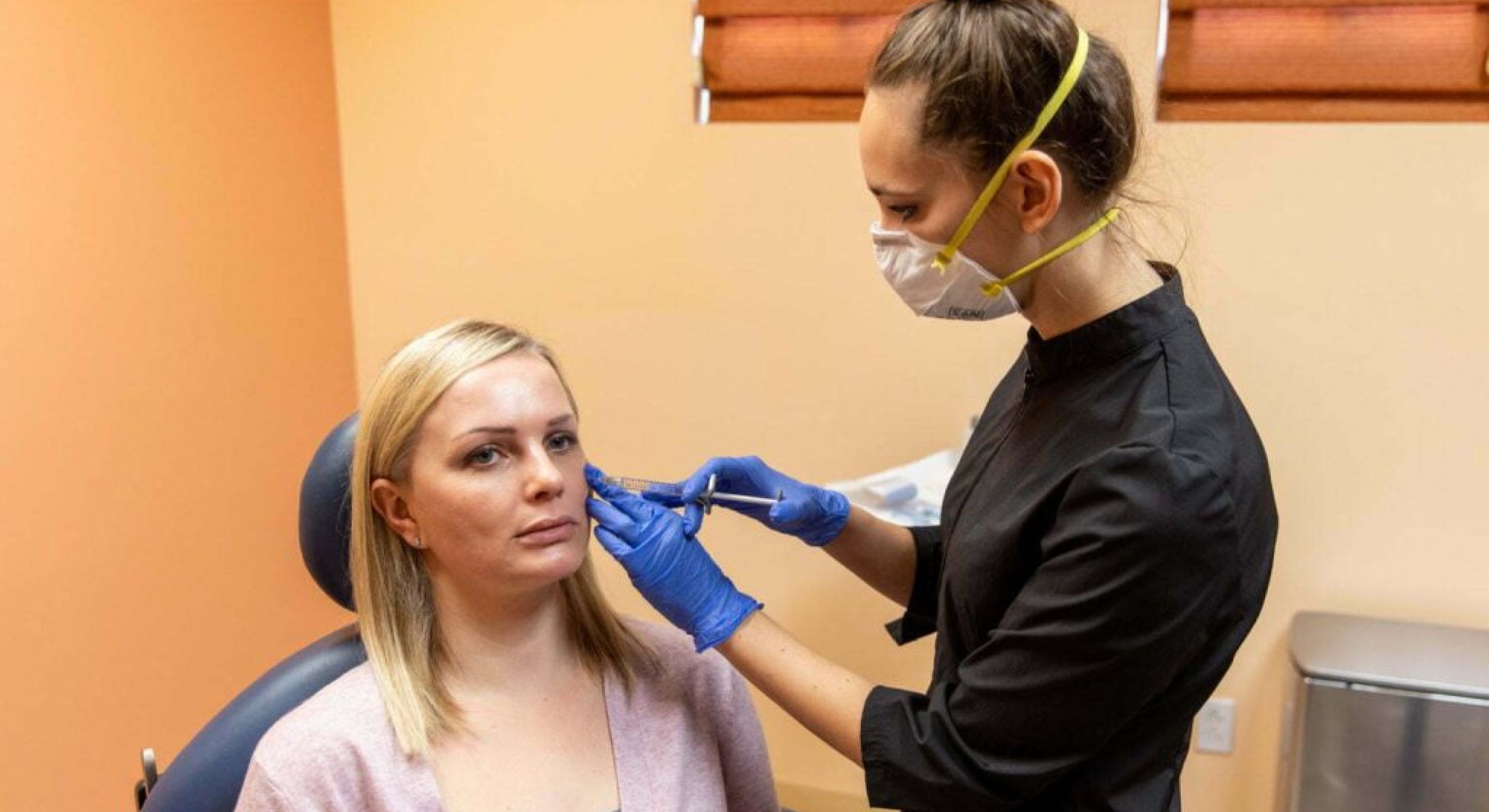 Patient receiving cosmetic treatment in clinic setting.