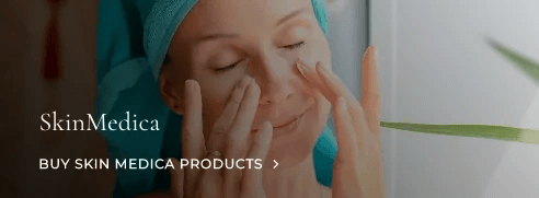 Woman applying SkinMedica skincare products.