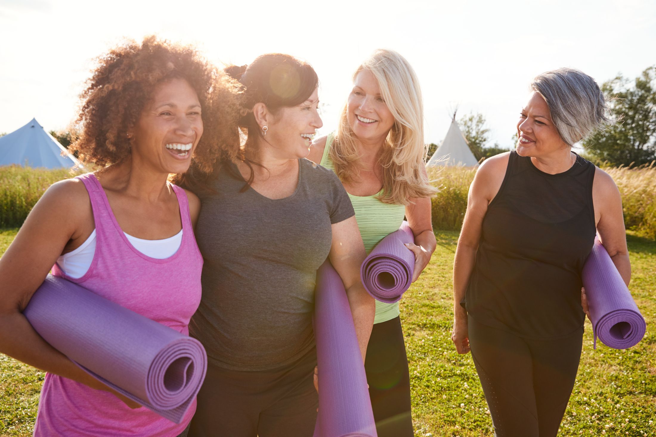 4 women with yoga mats talking about santa rosa vaginal rejuvenation