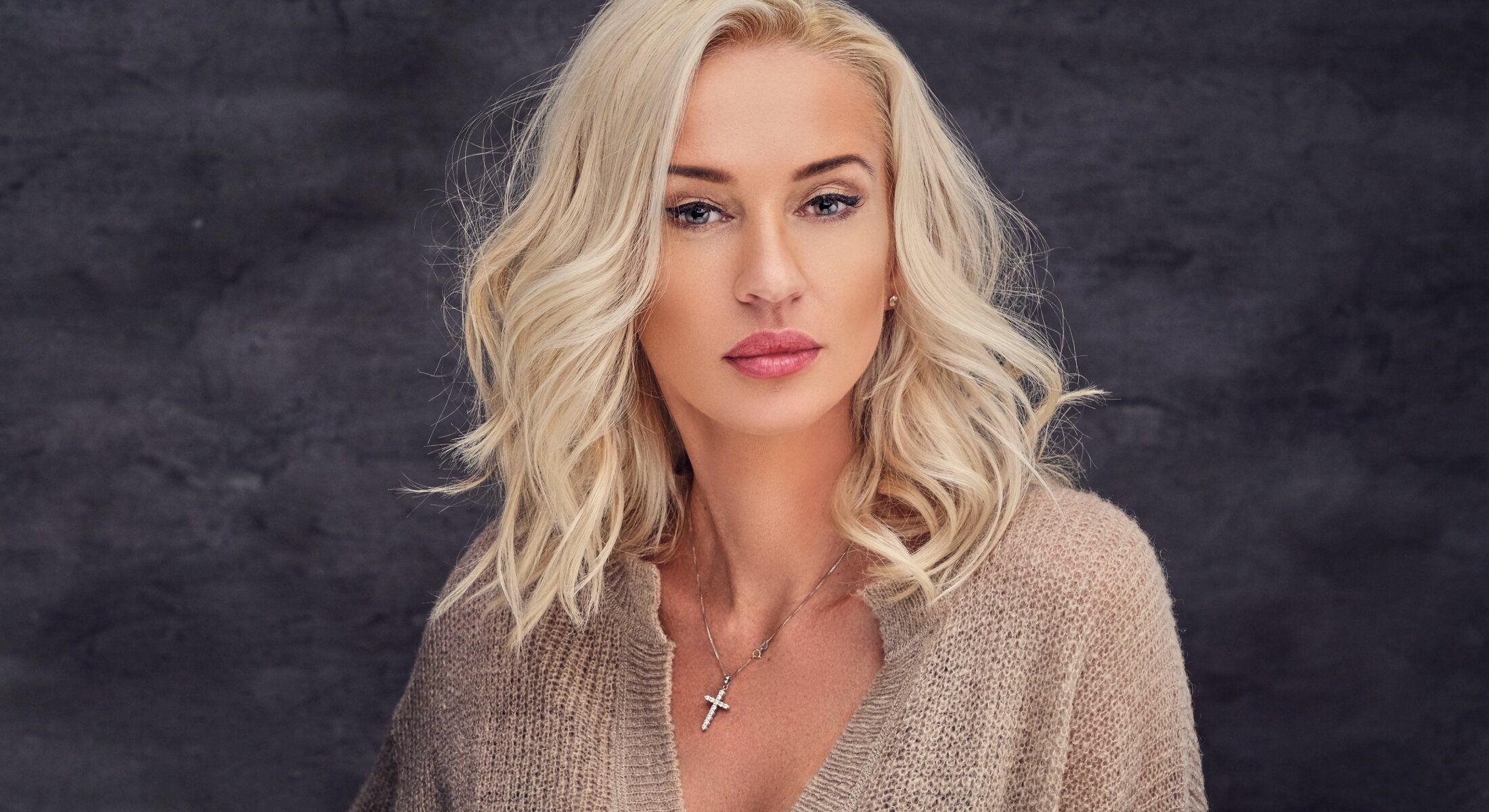 Blonde woman in soft sweater, portrait style.